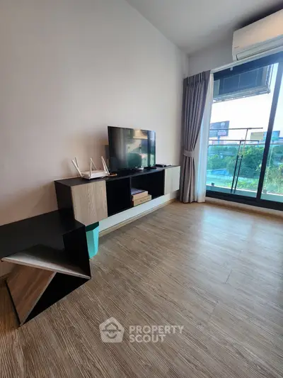 Modern living room with sleek TV stand and large window view