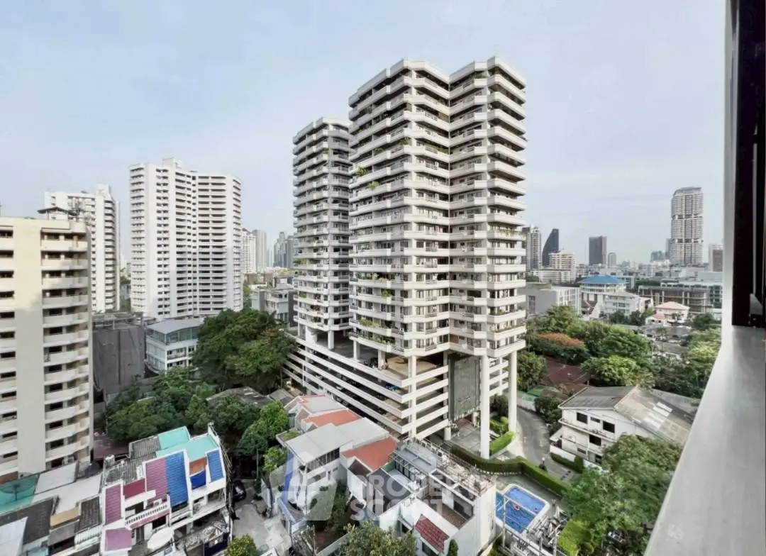 Stunning cityscape view of modern high-rise residential buildings with lush greenery and urban skyline.