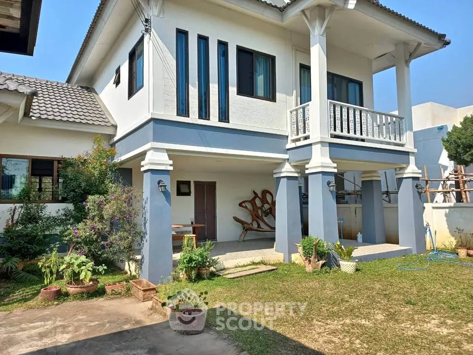 Charming two-story house with lush garden and spacious balcony, perfect for family living.