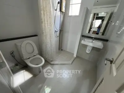 Modern bathroom with shower and toilet in a bright, clean design.