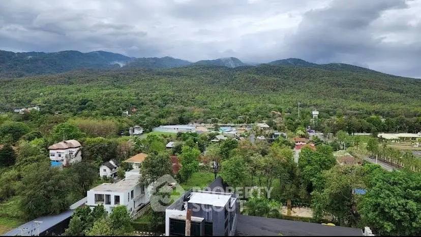 Stunning panoramic view of lush green landscape and distant mountains from a high vantage point.