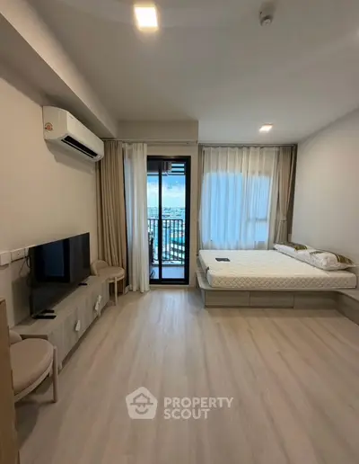 Modern studio apartment with balcony and natural light