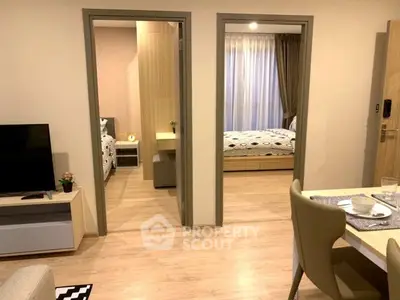 Modern apartment interior with open living area and two cozy bedrooms.