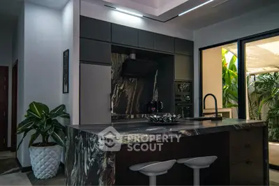 Luxurious modern kitchen with sleek design and lush garden view