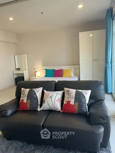 Modern studio apartment with stylish decor and cozy seating area.
