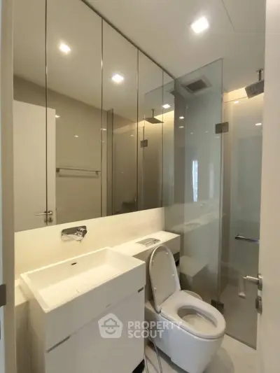 Modern bathroom with glass shower and sleek fixtures