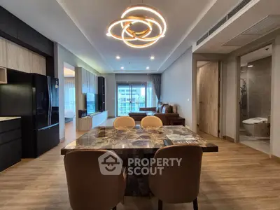 Luxurious open-plan living and dining area with modern lighting and elegant decor.