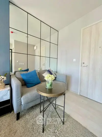 Modern living room with stylish sofa and decorative mirror wall