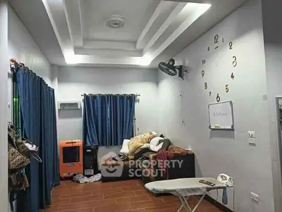 Cozy living room with modern ceiling design and wall clock decor