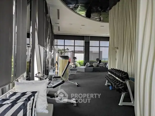 Luxurious gym with modern equipment and stylish design in upscale property.