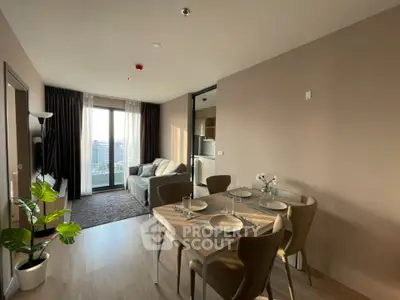 Modern living room with dining area and city view, featuring stylish furniture and natural light.