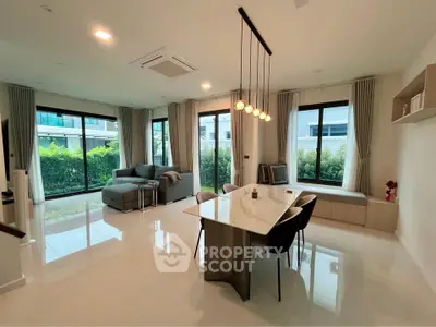 Spacious modern living room with elegant dining area and large windows