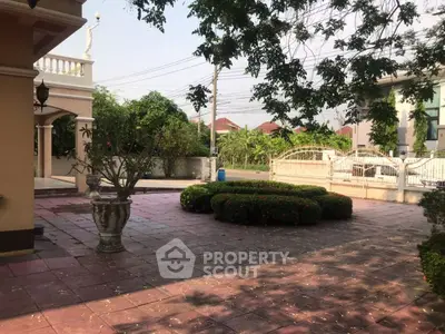 Spacious garden area with lush greenery and elegant landscaping in a residential property.