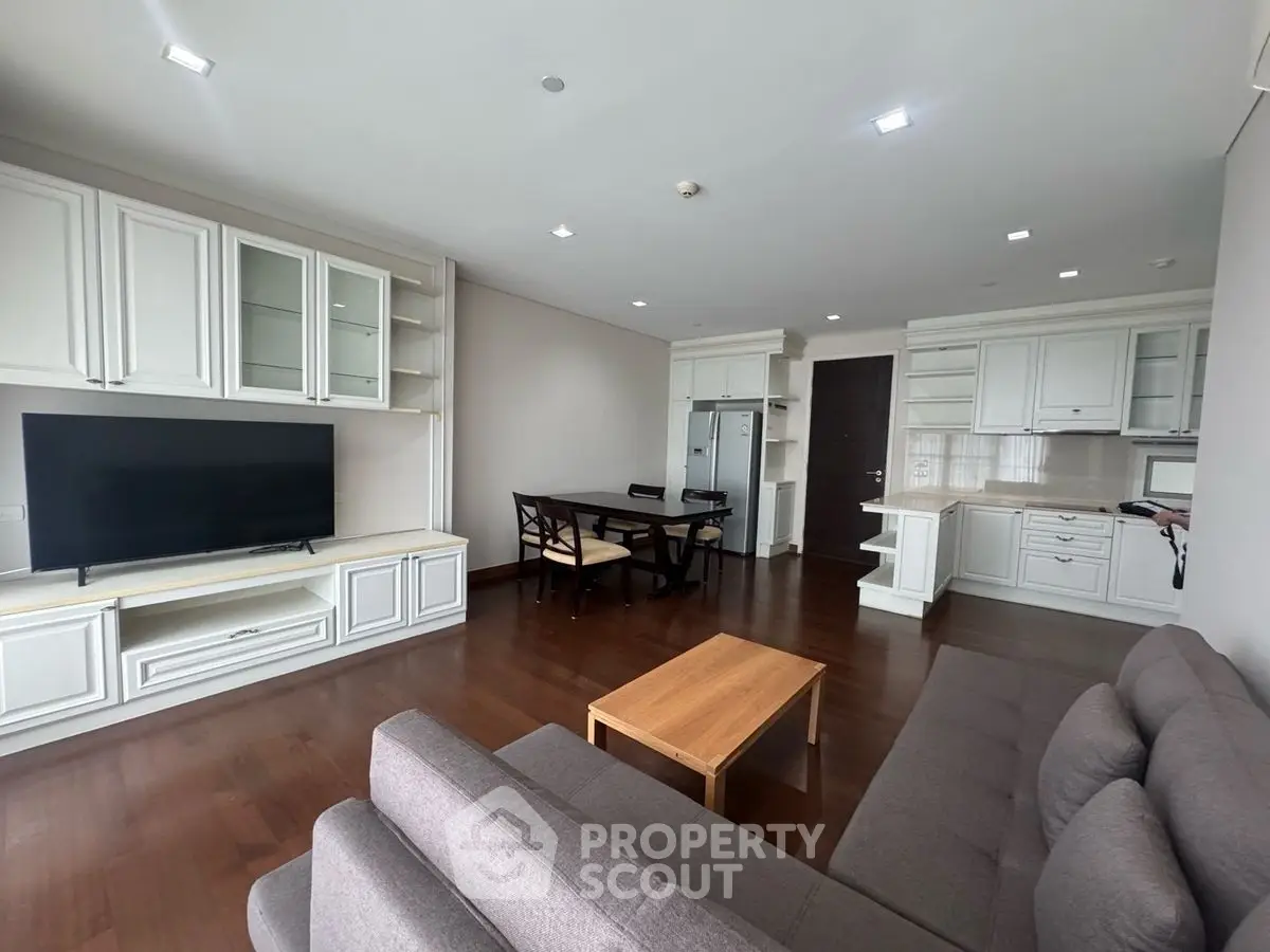 Spacious open-plan living room with modern kitchen and elegant furnishings.