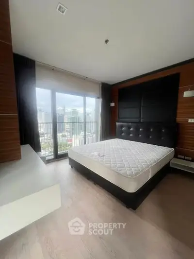 Spacious bedroom with city view and modern furnishings