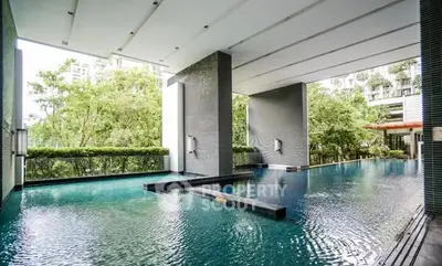 Luxurious modern pool area with sleek design and lush greenery
