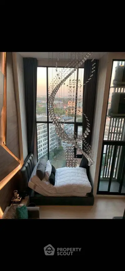 Luxurious bedroom with floor-to-ceiling windows and stunning city view