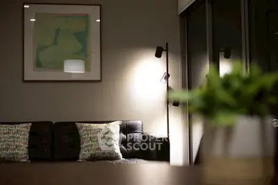 Stylish living room with modern decor and cozy lighting, perfect for relaxation.