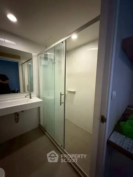 Modern bathroom with glass shower enclosure and sleek vanity
