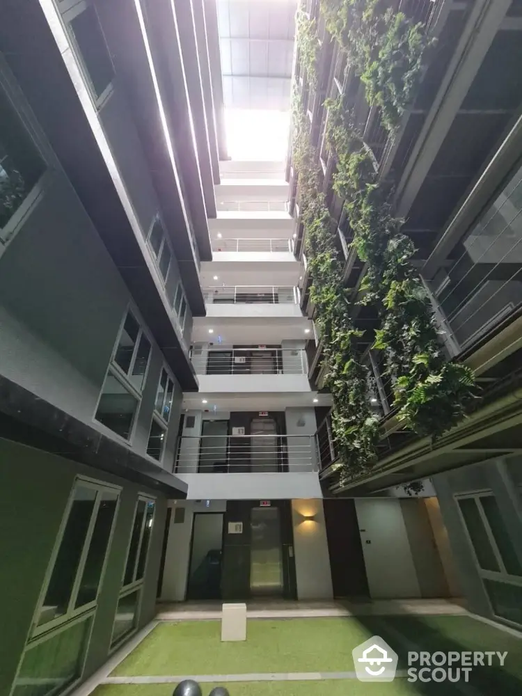 Modern apartment building with vertical garden and open atrium design