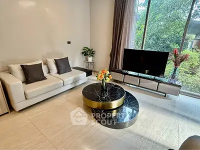 Modern living room with elegant decor and large window view