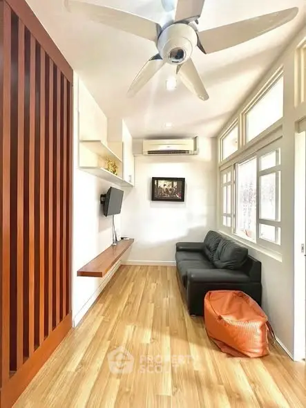 Stylish modern living room with wooden flooring and sleek furniture