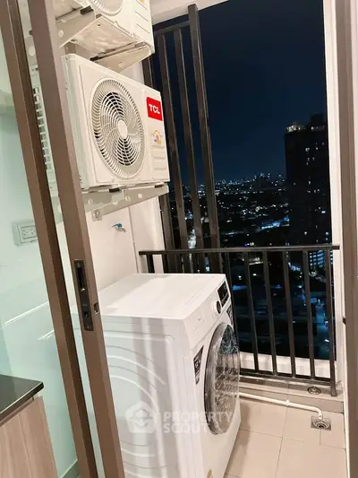 Modern apartment balcony with washing machine and city night view, ideal for urban living.