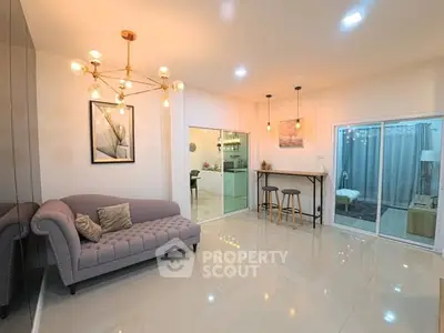 Spacious modern living room with elegant lighting and cozy seating area.