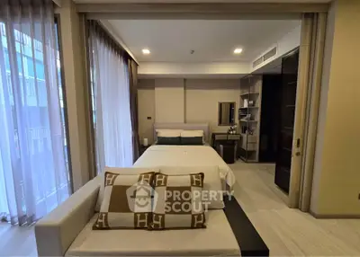 Modern bedroom with cozy seating area and stylish decor