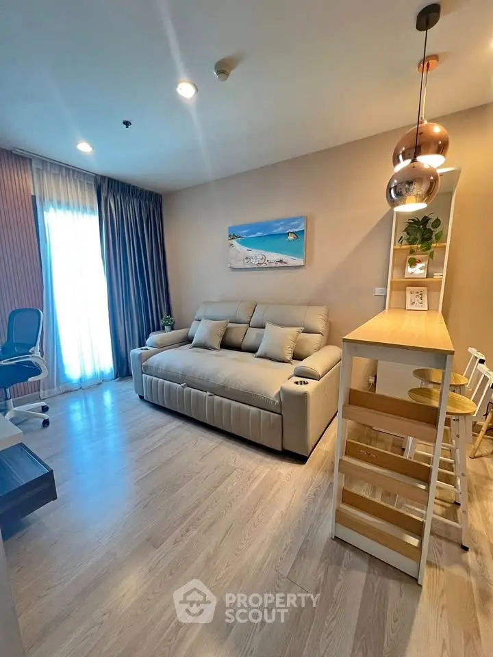 Modern living room with stylish decor and natural light, featuring a cozy sofa and chic lighting.