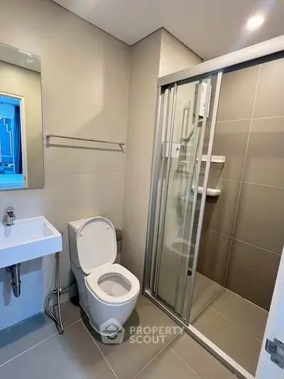 Modern bathroom with sleek shower enclosure and contemporary fixtures.
