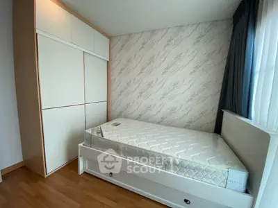 Modern bedroom with stylish wardrobe and cozy bed in bright natural light