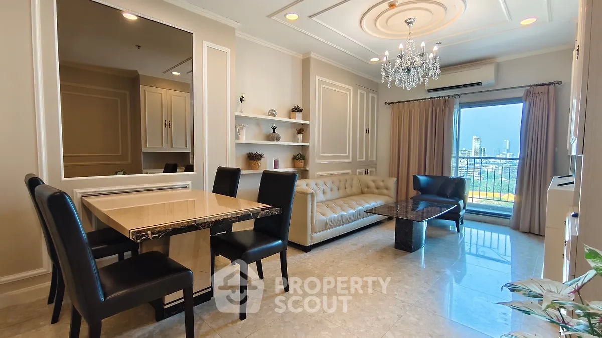 Luxurious living room with elegant chandelier and city view balcony in upscale apartment.