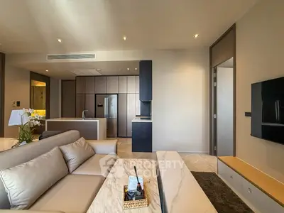 Luxurious modern living room with open kitchen, sleek furniture, and elegant decor in a high-end apartment.