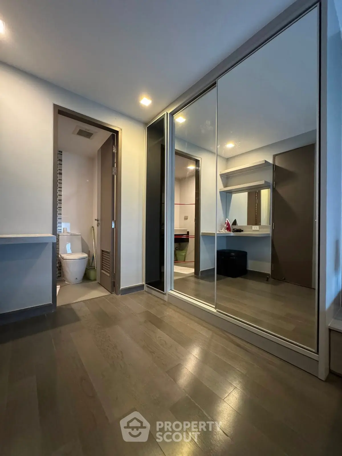 Spacious modern bedroom with mirrored closet and ensuite bathroom