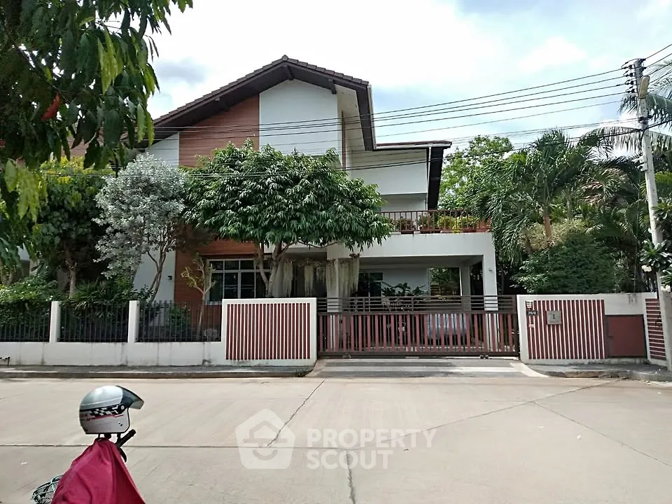 Charming suburban house with lush greenery and modern design, perfect for family living.