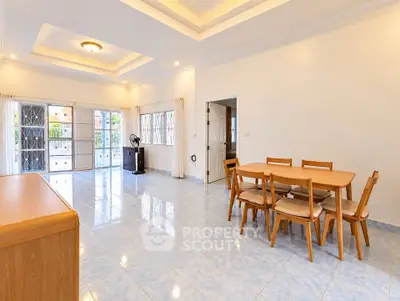 Spacious living room with dining area and natural light in modern home