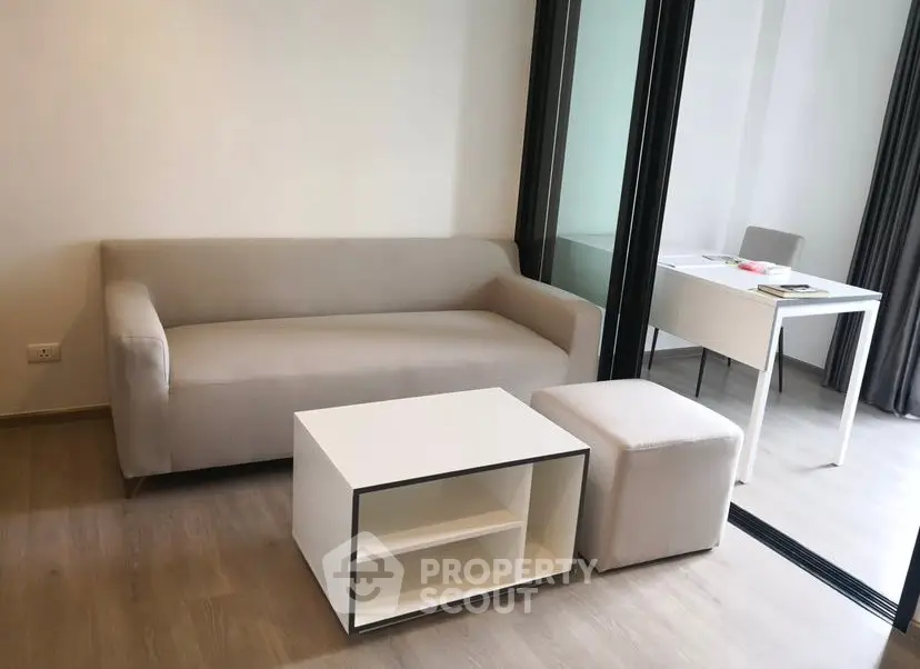 Modern living room with sleek furniture and natural light, perfect for urban living.