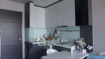 Modern kitchen with sleek cabinetry and integrated appliances in a stylish apartment.