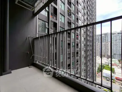 Spacious urban balcony with cityscape view in modern high-rise building.