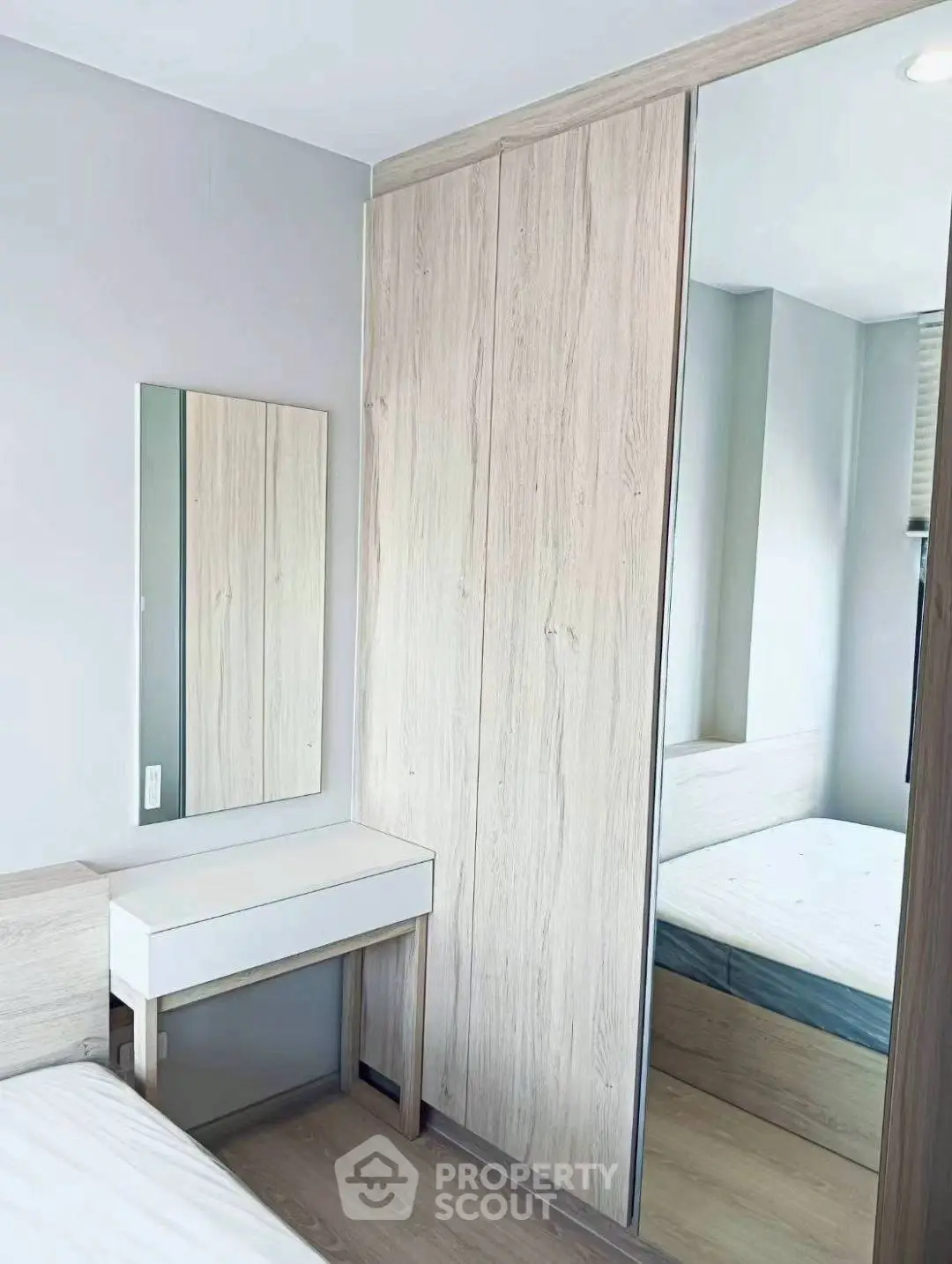 Modern bedroom with sleek wooden wardrobe and minimalist design