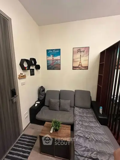 Cozy living room with modern decor and compact furniture, perfect for urban living.