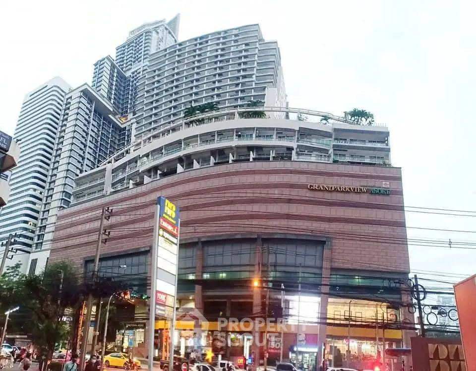 Stunning view of a modern high-rise building with retail spaces and lush rooftop gardens.