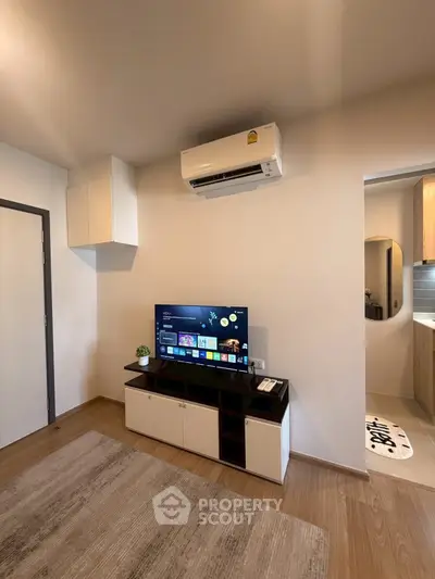 Modern living room with sleek TV unit and air conditioning