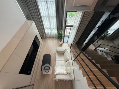 Stunning modern living room with high ceilings and large windows offering a breathtaking view.