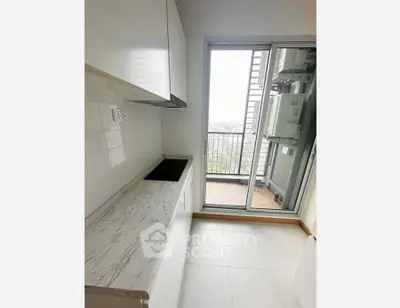Modern kitchen with sleek design and balcony view