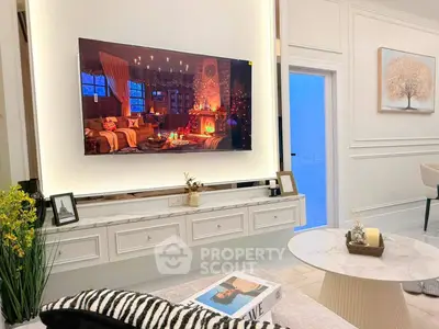Luxurious living room with modern decor and large wall-mounted TV