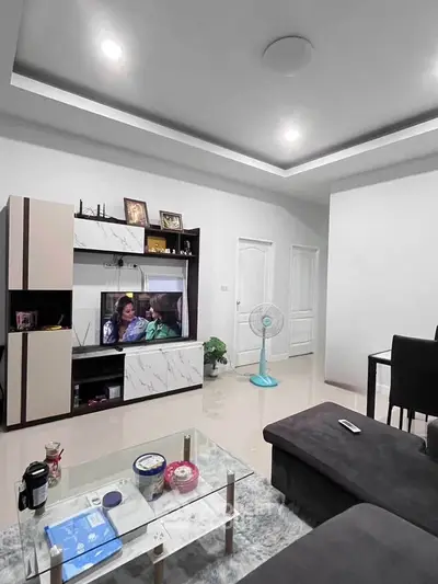 Modern living room with sleek entertainment unit and cozy seating area