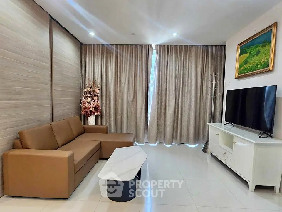 Modern living room with brown sofa, marble coffee table, and large TV, perfect for relaxation and entertainment.