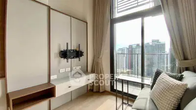 Modern living room with city view and balcony access in high-rise apartment.